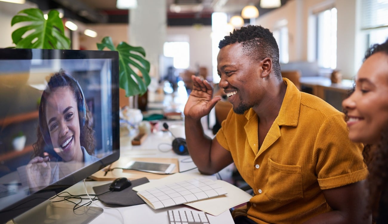 Young employees chatting over video-call