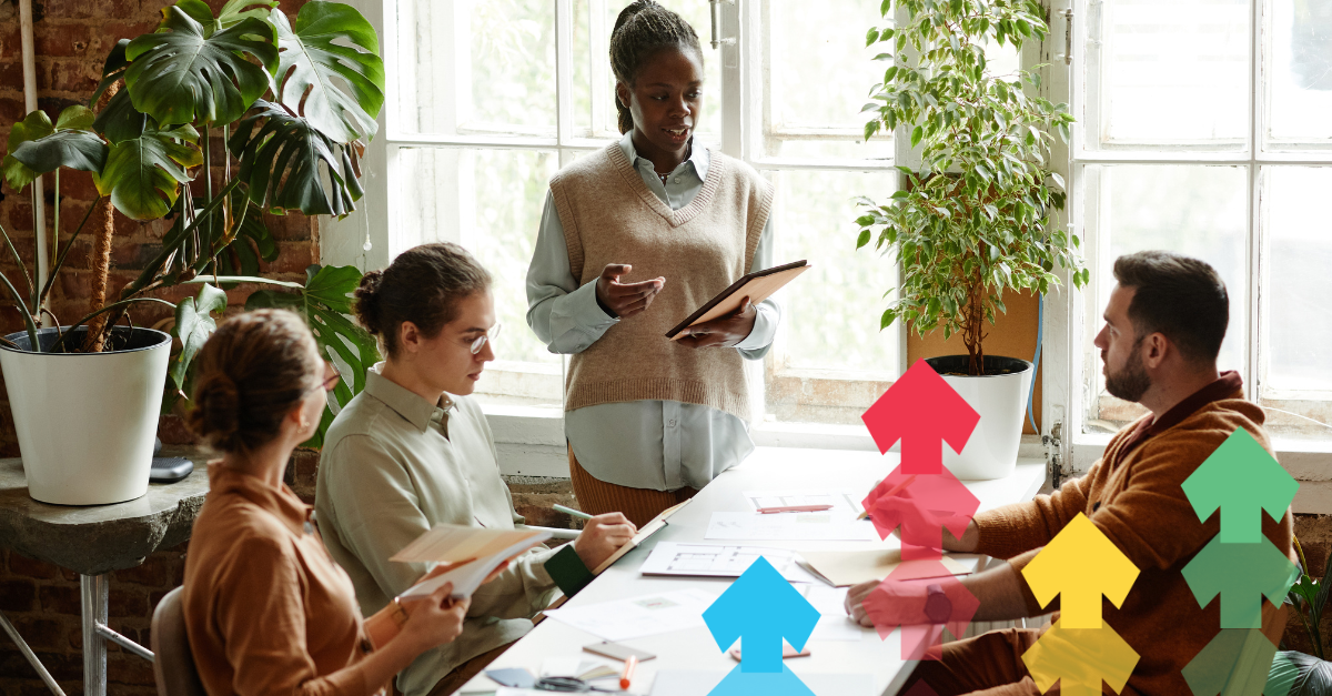 Group of employees listening to leader in modern office 